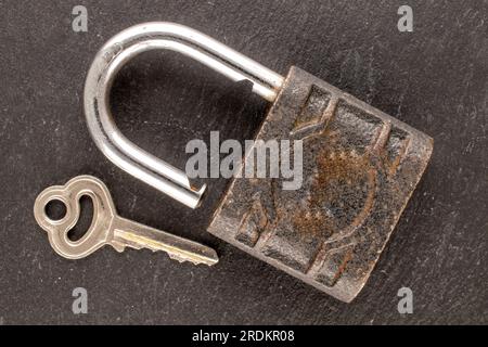 One door lock and key on slate stone, close-up, top view. Stock Photo