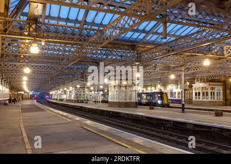 Scotrail Siemens class 380 electric train calling at Paisley Gilmour street railway station, Scotland, UK at night Stock Photo