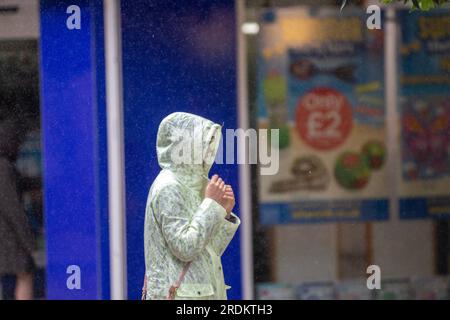 Preston Lancashire.  UK Weather 22 July 2023. Summer sales, shops, and shoppers on a rainy day in the city centre. Forecasters say: 'Rain, heavy at times, through Saturday & Sunday is likely to cause some disruption, particularly to outdoor events. Credit: MediaWorldImages/AlamyLiveNews Stock Photo