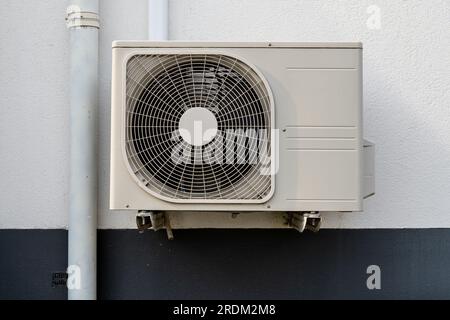 air conditioner condenser unit at exterior wall Stock Photo