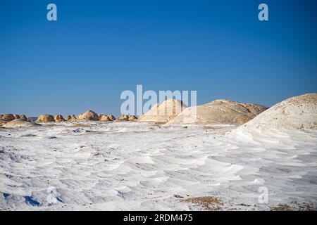 April 13, 2023, Qsar El Farafra, Egypt: Once as a seabed million years ago, the White Desert in Egypt is now filled with different calcified limestone rocks which are shaped over time through wind and sand. From erosion of volcanos and a quartz mountain, to weathering rocks and white chalk rock formations, Black and White Desert is part of the Frarafra depression in the Sahara Desert and locates at the Western part of Egypt. The vast desert links to main roads that are close to the Libyan-Egyptian border where it is now heavily armed with military presence. The bizarre natural landscape rising Stock Photo