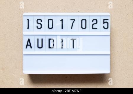 Lightbox with word ISO 17025 audit on wood background Stock Photo