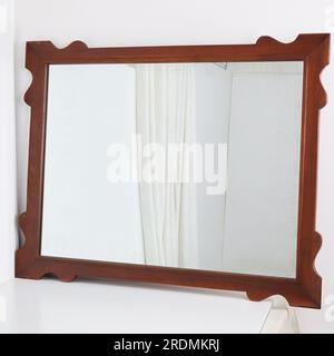 Vintage decorative mirror. Retro wooden frame mirror. Stock Photo
