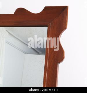 Vintage decorative mirror. Retro wooden frame mirror. Stock Photo