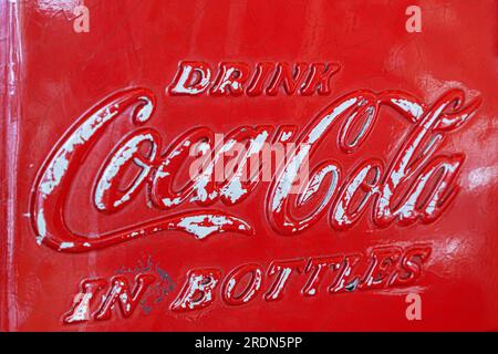 Vintage Metal Coca Cola Vending Machine with Drink Coca Cola in Bottles on the outside Stock Photo