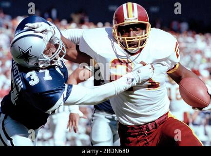 Atlanta Falcons linebacker Robert Lyles (54) pulls on the jersey of  Washington Redskins running back Earnest Byner (21) during first quarter  NFL Divisional playoff action, Jan. 4, 1992, at RFK Stadium in