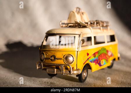 Small hippie yellow van toy. Vacation, traveling concept Stock Photo