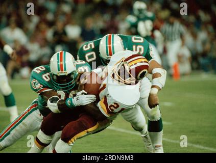 Atlanta Falcons linebacker Robert Lyles (54) pulls on the jersey of  Washington Redskins running back Earnest Byner (21) during first quarter  NFL Divisional playoff action, Jan. 4, 1992, at RFK Stadium in