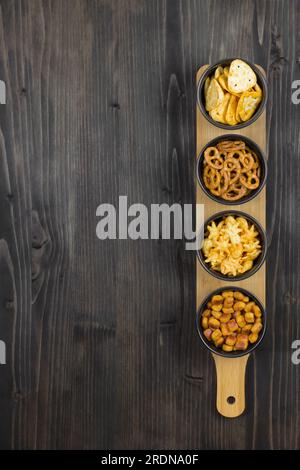Lager beer and snacks on stone table. Nuts, chips, pretzel. Top view with copy space Stock Photo