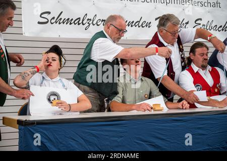 Markt Erlbach, Germany. 22nd July, 2023. The participants snort the last  crumbs of tobacco before the judges do the scoring. Within one minute, the  participants of the 54th German Snuff Championship have