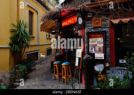 Bellagio, Lombardy, Italy - February 18, 2022. Picturesque traditional colorful street view in Bellagio on the shore of the Como Lake, Lombardy, Italy Stock Photo