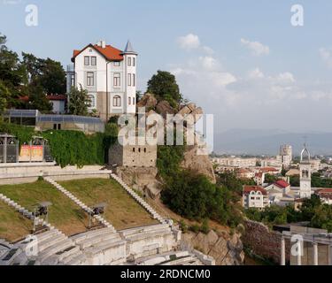 Roman era Theatre of Philippopolis in Plovdiv with house situated above beside a rock formation, Bulgaria, the oldest city in Europe. Stock Photo