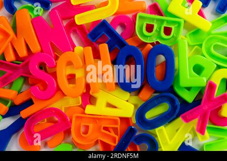 This stock image shows a set of colorful letter magnets arranged to spell out the words 'School' on a plain white background Stock Photo