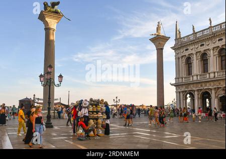 Columns of St Mark and St Todaro in Riva degli Schiavoni monumental waterfront with a corner of the Marciana Library, Venice, Veneto, Italy Stock Photo