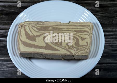 Traditional tahini halva with chocolate or Halawa Tahiniya, the primary ingredients in this confection are sesame butter or paste (tahini) sugar, gluc Stock Photo