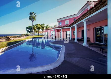 09-24-2015 Saint-Tropez, France.   Exterior of Mediterranean Villa in French Riviera (between Cannes and Saint-Tropez) and pool. Palm trees garden. Fa Stock Photo
