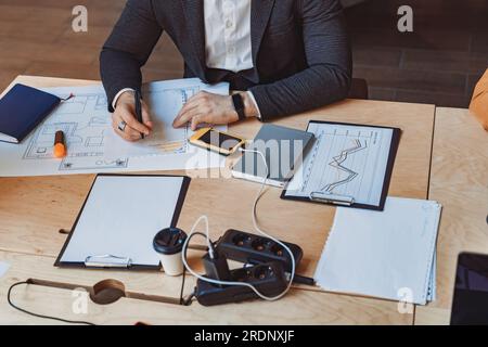 Close up of male architect engineer making notes during work with a construction project Stock Photo
