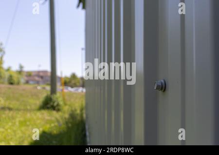Gray metal fence with bolt - blurred background Stock Photo
