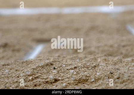 Sandy beach close up - light brown sand with white particles Stock Photo