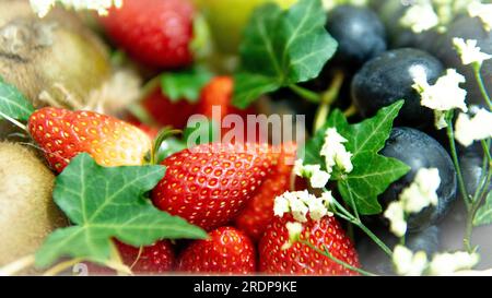 Selective focus of Composition of various exotic fruits isolated. Fruits are such as pear kiwi grape and strawbeery. Delicious and ripe fruit Stock Photo