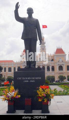 Statue of the revered Ho Chi Minh in Ho Chi Minh City, formerly Saigon, Vietnam, Asia; Ho Chi Minh city, formerly known as Saigon, is the largest city in Vietnam. Ho Chi Minh city holds many historical places and statues; here fresh flowers have been placed on the statue; out of site police guard it Stock Photo