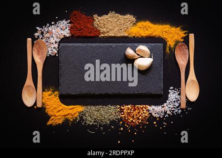 Set of Various spices on black stone table. Top view with copy space. Stock Photo