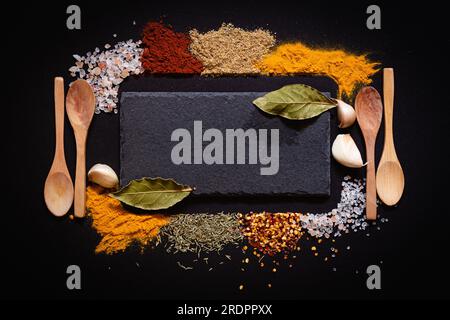 Set of Various spices on black stone table. Top view with copy space. Stock Photo
