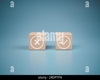 Wooden blocks with wrong and right symbols on light blue background. Stock Photo