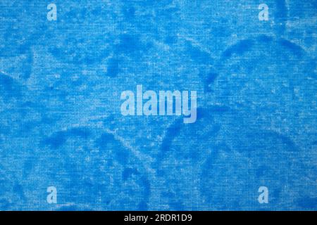 Canvas painted blue with a round sponge. Blue background with textile structure. Stock Photo