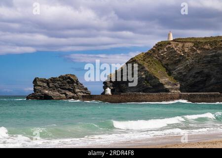 Sea View of Waves Against the Harbour Wall with Look Out Hut, Striated Rocky Coast and Shoreline Swell in Early Summer. Portreath Beach, Cornwall. Stock Photo