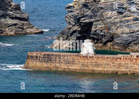 Colourful Sea View with Detail of the Harbour Wall and ‘Monkey House’ Look Out Hut, Cliffs Striation and Light Ocean Swell. Portreath Cornwall. Stock Photo