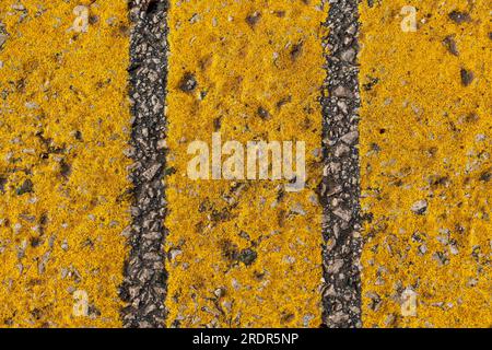 Yellow strip pattern on asphalt road as abstract background, top view Stock Photo