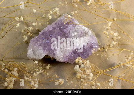 set of various amethyst natural mineral stones and gemstones on grey background top view Stock Photo