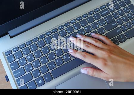 Female hands or woman office worker typing on the keyboard Stock Photo