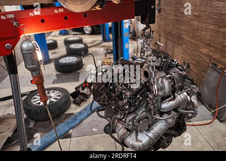 A car mechanic inspects shock absorber, springs and stabilizer bars with a  flashlight. Car on a repair stand. Technical service station for car Stock  Photo - Alamy