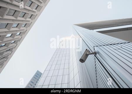 Outdoor CCTV video surveillance security camera installed on the building in the city Stock Photo