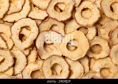 Dried apple chips full frame close up as background Stock Photo