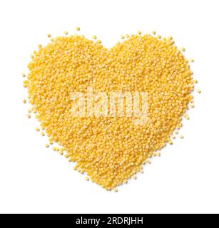 Raw dry yellow millet in heart shape isolated on white background close up Stock Photo
