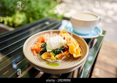 Potato waffles, Poached egg, avocado cream with salmon and egg . Healthy breakfast, protein. Restaurant dish.  Stock Photo