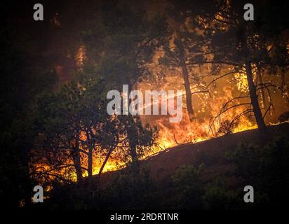 Rhodes Island. 22nd July, 2023. This photo taken on July 22, 2023 shows a massive wildfire raging the Rhodes island in Greece. At least 2,000 residents and holidaymakers were evacuated by sea in the fire-stricken areas of Rhodes island in Greece on Saturday evening, authorities said. Credit: Argiris Mantikos/Xinhua/Alamy Live News Stock Photo