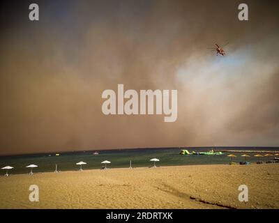 Rhodes Island. 22nd July, 2023. A helicopter is seen above the Rhodes island in Greece, July 22, 2023. At least 2,000 residents and holidaymakers were evacuated by sea in the fire-stricken areas of Rhodes island in Greece on Saturday evening, authorities said. Credit: Argiris Mantikos/Xinhua/Alamy Live News Stock Photo