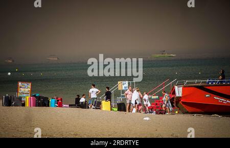 Rhodes Island. 22nd July, 2023. People wait to evacuate after a wildfire hit the Rhodes island in Greece, July 22, 2023. At least 2,000 residents and holidaymakers were evacuated by sea in the fire-stricken areas of Rhodes island in Greece on Saturday evening, authorities said. Credit: Argiris Mantikos/Xinhua/Alamy Live News Stock Photo