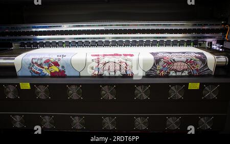 Bangkok, Thailand - June 6, 2023: Sublimation printer printing T shirt show in Garment and Textile Manufacturing Industry. Stock Photo