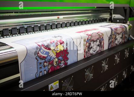 Bangkok, Thailand - June 6, 2023: Sublimation printer printing T shirt show in Garment and Textile Manufacturing Industry. Stock Photo