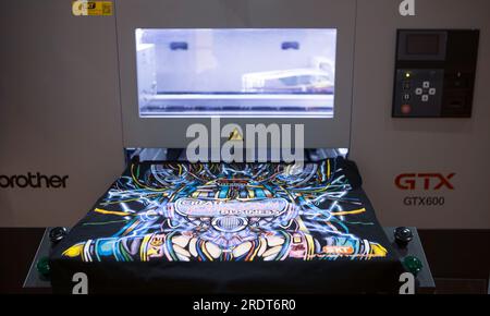 Bangkok, Thailand - June 6, 2023: Sublimation printer printing T shirt show in Garment and Textile Manufacturing Industry. Stock Photo