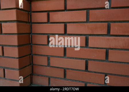 Red brick and brick edge from pillar in front of wall as texture background Stock Photo
