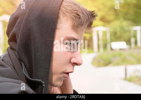 Profile portrait of a young man with black hoodie Stock Photo