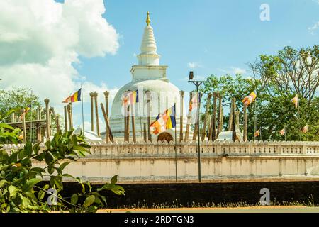 thuparamaya White stupa with flags on blue sky background, Anuradhapuraya, Sri lanka. Stock Photo