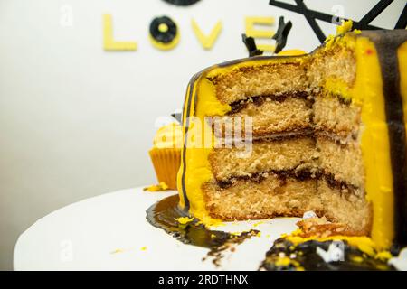 Cake with yellow frosting on top and the word love. Stock Photo
