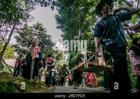 Residents do a procession by bringing natural products from agriculture and plantations called the earth alms tradition Stock Photo